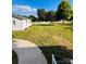 Wide backyard and view of the side of the house, highlighted by well-kept lawns and side bushes at 716 E Union St, Marshville, NC 28103