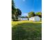 Wide backyard and view of the back of the house and second building, highlighted by well-kept lawns at 716 E Union St, Marshville, NC 28103