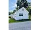 Exterior view of a home showcasing a neatly landscaped yard with a gravel driveway at 716 E Union St, Marshville, NC 28103