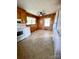 Kitchen with wood cabinets, white appliances, and laminate flooring at 716 E Union St, Marshville, NC 28103