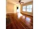 Sunlit living room featuring hardwood floors, fireplace, and large windows at 716 E Union St, Marshville, NC 28103