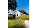 Exterior side view of the property with green bushes lining the home, and well maintained lawn at 716 E Union St, Marshville, NC 28103