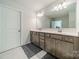 Bathroom with a double sink vanity, a large mirror, tile flooring, and overhead lighting at 804 Lyndon Station Dr, Pineville, NC 28134