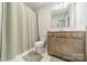 Bathroom with a neutral vanity, tiled floors, a toilet, mirror and a shower with a curtain at 804 Lyndon Station Dr, Pineville, NC 28134