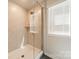 Modern shower with glass enclosure, tiled walls and a window for plenty of natural light at 804 Lyndon Station Dr, Pineville, NC 28134