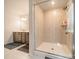 A well-lit bathroom featuring a glass-enclosed shower, gray vanity, and neutral tile, creating a spa-like experience at 804 Lyndon Station Dr, Pineville, NC 28134