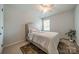 A cozy bedroom with plush carpet, ceiling fan, a decorative rug, and ample natural light at 804 Lyndon Station Dr, Pineville, NC 28134