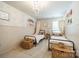 Charming bedroom featuring twin beds, patterned wallpaper, decorative chandelier and ample natural light at 804 Lyndon Station Dr, Pineville, NC 28134