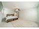 Spacious bedroom with a large bed and a comfortable bench with storage in the base at 804 Lyndon Station Dr, Pineville, NC 28134