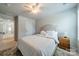 A well-lit bedroom featuring neutral walls, ceiling fan, and a large inviting bed at 804 Lyndon Station Dr, Pineville, NC 28134