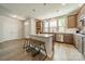 Open-concept kitchen with stainless steel appliances, a center island with seating, and light wood floors at 804 Lyndon Station Dr, Pineville, NC 28134