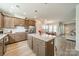 Bright eat-in kitchen features an island with pendant lighting, granite countertops, and stainless steel appliances at 804 Lyndon Station Dr, Pineville, NC 28134
