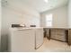 Functional laundry room with washer, dryer, built-in shelving and counter, offering convenience and organization at 804 Lyndon Station Dr, Pineville, NC 28134
