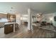 Open-concept floor plan showcasing a living room, dining area, and kitchen with a large island at 804 Lyndon Station Dr, Pineville, NC 28134