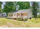 Rear exterior of the home with a wooden deck, dining furniture and a well-maintained lawn at 814 Independence Dr, Wingate, NC 28174