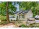 Inviting exterior with a cozy porch and swing, nestled in a serene, tree-filled yard at 814 Independence Dr, Wingate, NC 28174