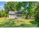 Charming home with lush green lawn and mature trees providing ample shade and curb appeal at 814 Independence Dr, Wingate, NC 28174