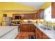 Bright eat-in kitchen with modern stainless steel appliances, wood floors, and granite countertops at 814 Independence Dr, Wingate, NC 28174