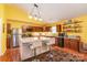 Bright kitchen featuring wooden cabinets, stainless steel appliances, and an island with barstools at 814 Independence Dr, Wingate, NC 28174