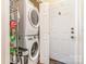 Convenient laundry area equipped with stacked washer and dryer, plus storage shelving at 814 Independence Dr, Wingate, NC 28174