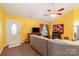 Sunny living room with yellow walls, a grey couch, and a fireplace at 814 Independence Dr, Wingate, NC 28174