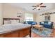 Comfortable living room featuring a bed, couches, wood floors, a ceiling fan, and natural light at 814 Independence Dr, Wingate, NC 28174