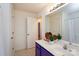 Bright bathroom featuring a white sink, vanity, and decorative accents, with a view into a doorway at 8233 Christmas Ct, Charlotte, NC 28216