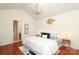 Primary bedroom with vaulted ceilings, modern chandelier and neutral decor at 8233 Christmas Ct, Charlotte, NC 28216