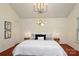 Primary bedroom with vaulted ceilings, modern chandelier and neutral decor at 8233 Christmas Ct, Charlotte, NC 28216
