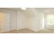 Bright bedroom with neutral carpet, white walls, and a window providing natural light at 8233 Christmas Ct, Charlotte, NC 28216