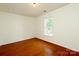 Bright bedroom with hardwood flooring and large window at 8233 Christmas Ct, Charlotte, NC 28216