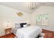 Primary bedroom with vaulted ceilings, modern chandelier and neutral decor at 8233 Christmas Ct, Charlotte, NC 28216