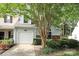 Charming home featuring a white garage door, lush landscaping, and a well-kept lawn at 8233 Christmas Ct, Charlotte, NC 28216