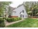 Well-maintained home exterior featuring green lawn, manicured bushes, and ample sunlight at 8233 Christmas Ct, Charlotte, NC 28216