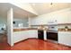 Open kitchen with white cabinets and stainless steel appliances at 8233 Christmas Ct, Charlotte, NC 28216