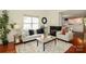 A bright living room that connects to dining area with a fireplace at 8233 Christmas Ct, Charlotte, NC 28216