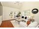 Bright living room with ceiling fan, hardwood floors, and French doors to the back yard at 8233 Christmas Ct, Charlotte, NC 28216