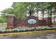 Brick Holly Ridge community sign featuring flower beds with white flowers at 8233 Christmas Ct, Charlotte, NC 28216