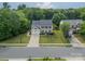 An aerial view of a lovely home with mature trees and lush landscaping on a quiet street at 8707 Darcy Hopkins Dr, Charlotte, NC 28277