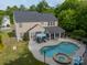 Beautiful home showcasing a pool with spa, a spacious patio, and a sunroom for year-round enjoyment at 8707 Darcy Hopkins Dr, Charlotte, NC 28277