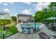 Inviting backyard with pool, spa, and patio featuring bright blue chairs, perfect for lounging and entertaining guests at 8707 Darcy Hopkins Dr, Charlotte, NC 28277