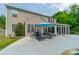 Charming home featuring a large concrete patio and sunroom, perfect for outdoor lounging and entertaining at 8707 Darcy Hopkins Dr, Charlotte, NC 28277