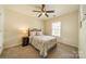 Comfortable bedroom with ceiling fan features a wrought iron bed frame and large window at 8707 Darcy Hopkins Dr, Charlotte, NC 28277