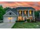 Charming two-story home featuring stately columns, a well-manicured lawn, and a welcoming two-car garage at 8707 Darcy Hopkins Dr, Charlotte, NC 28277