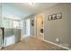 Second floor hallway with neutral walls and carpet, featuring doors leading to various rooms at 8707 Darcy Hopkins Dr, Charlotte, NC 28277