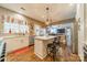 Bright eat-in kitchen featuring an island, stainless steel appliances, and hardwood flooring at 8707 Darcy Hopkins Dr, Charlotte, NC 28277