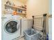 Well-organized laundry room with a washer, dryer, storage shelves, and a folding rack for added convenience at 8707 Darcy Hopkins Dr, Charlotte, NC 28277