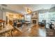 Bright living room with fireplace, hardwood floors, and open layout leading to the kitchen at 8707 Darcy Hopkins Dr, Charlotte, NC 28277