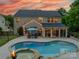 Backyard oasis showcasing a luxurious pool, spa, and patio area perfect for outdoor entertaining at 8707 Darcy Hopkins Dr, Charlotte, NC 28277