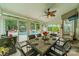 Inviting sunroom boasts a dining table, comfortable seating, and views of the pool area, ideal for entertaining at 8707 Darcy Hopkins Dr, Charlotte, NC 28277
